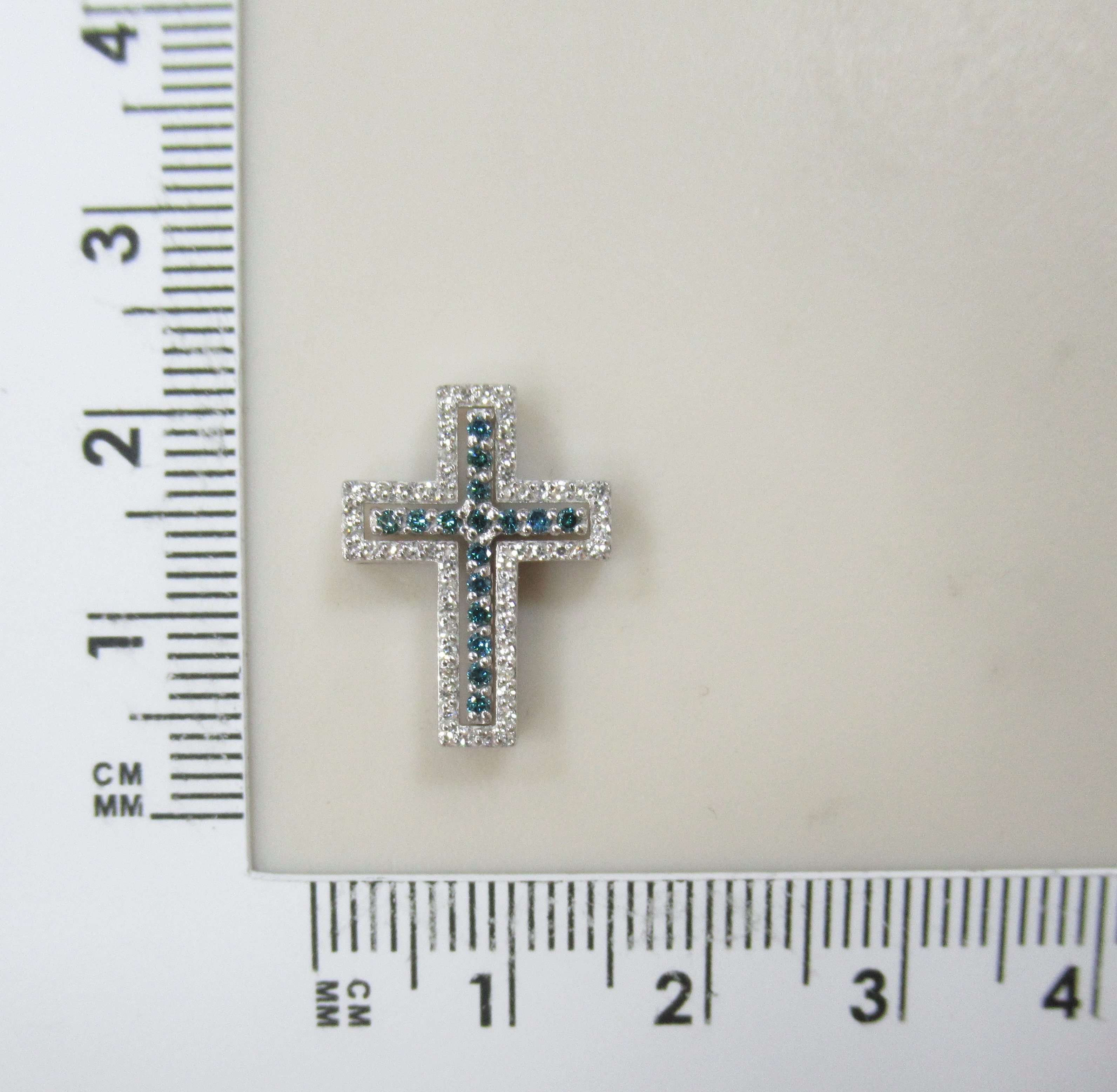 Подвеска-крест из белого золота с голубыми бриллиантами